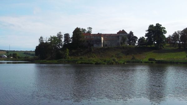 © Andrei  Kolyaskin - Lake  and   Svirzh  Castle  from  15th  century  in   village  Svirzh  of  Lviv  region , Ukraine .
