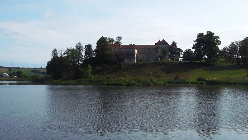 © Andrei  Kolyaskin - Lake  and   Svirzh  Castle  from  15th  century  in   village  Svirzh  of  Lviv  region , Ukraine .