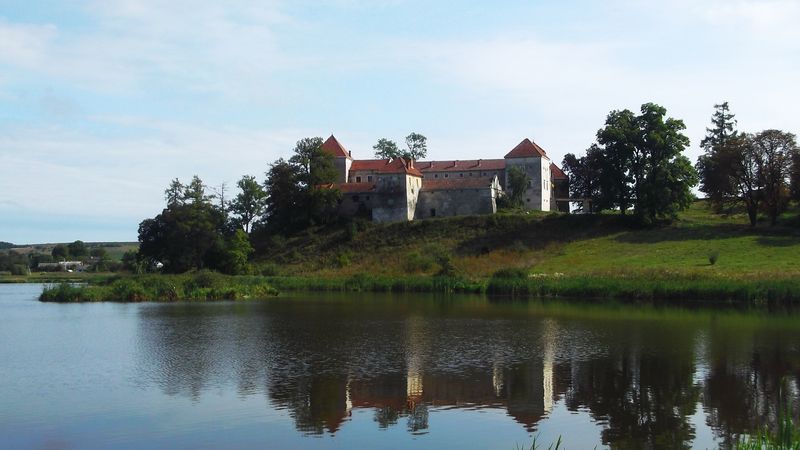 © Andrei  Kolyaskin - Lake  and   Svirzh  Castle  from  15th  century  in   village  Svirzh  of  Lviv  region , Ukraine .