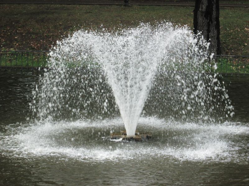 © Andrei  Kolyaskin - Fountain  on  the  pond  of  central  park  of  Ivano - Frankivsk  City , Ukraine .