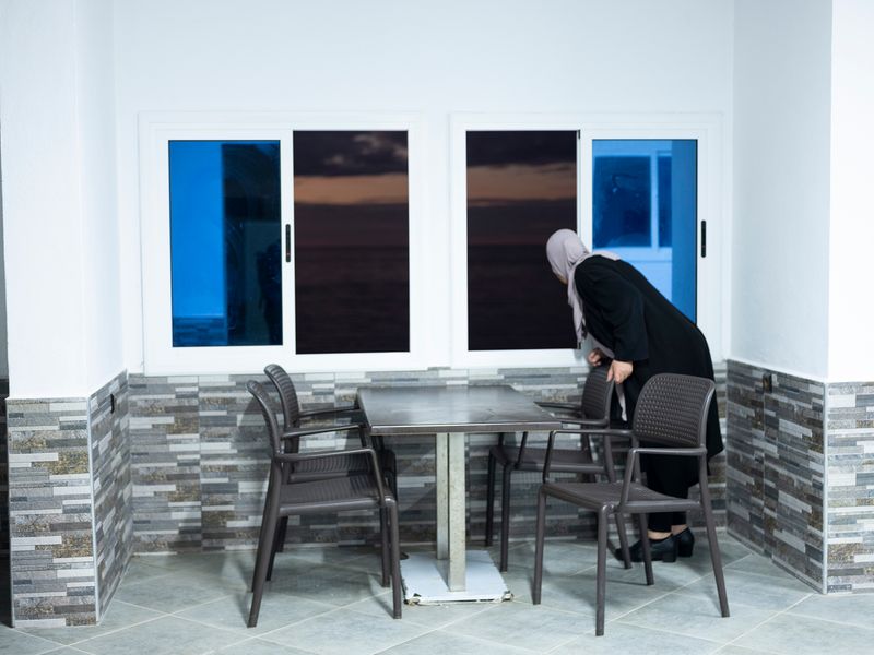 © MAryam Touzani - My mother looks at the Mediterranean Sea; she does not allow me to photograph her.