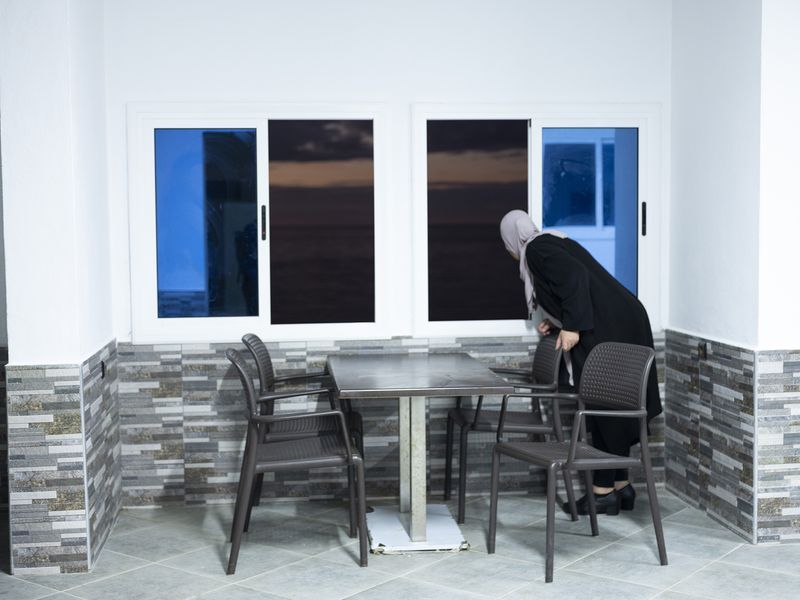 © MAryam Touzani - My mother looks at the Mediterranean Sea; she does not allow me to photograph her.