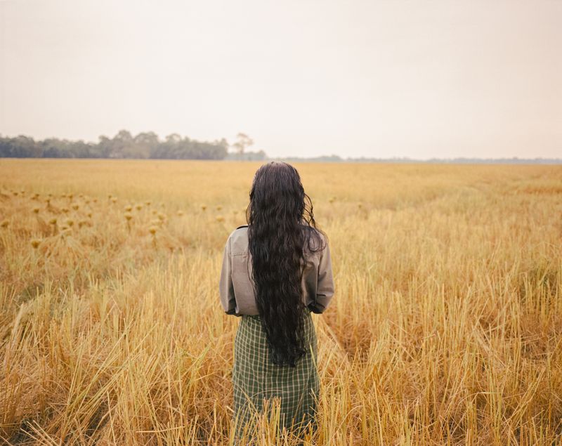 © András Zoltai - A Mishing woman having a rest at rice harvest in Jengrai Chapori.