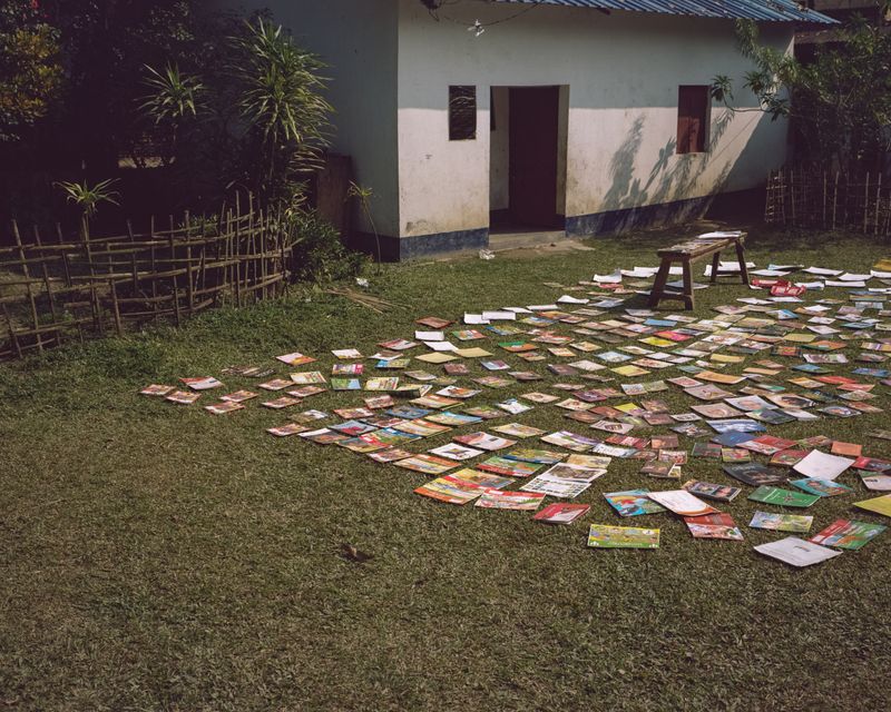 © András Zoltai - Textbooks are laid out to dry in the schoolyard, preserved from the wet conditions of the floodplain.