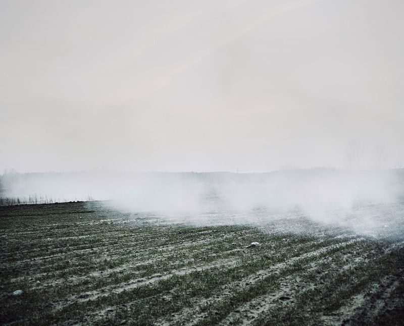 © Jasper Walter Bastian - Clouds of smoke from an old farm building burning down in Stalgonys.Stalgonys, Lithuania, 2015.