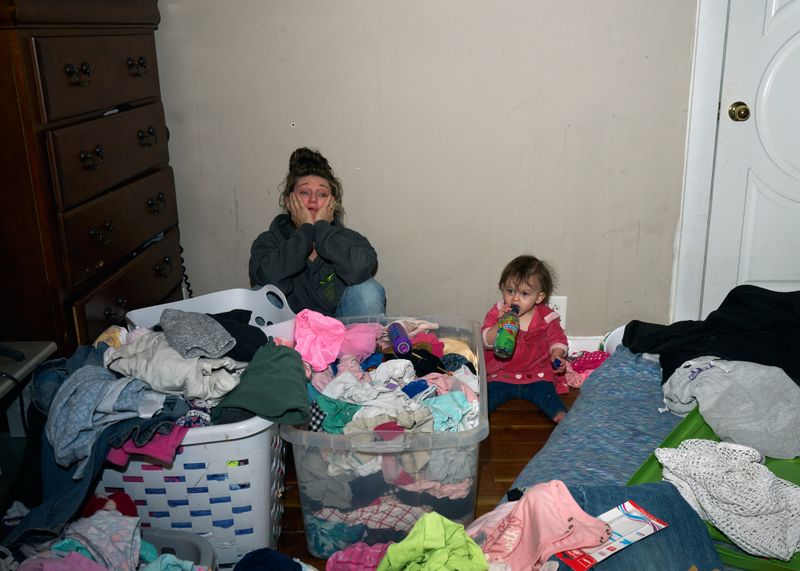 © Stacy Kranitz - Mayron breaks down from exhaustion while watching her daughter, Zoey.