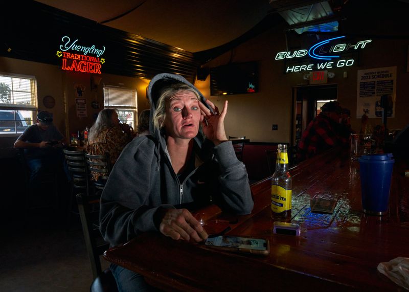 © Stacy Kranitz - Mayron stops by a bar after work to have a few drinks before going home to care for her children.