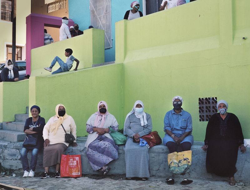 © Ayesha Kazim - A group of women from the community wait for their meals outside of the Bo Kaap Cultural Hub.
