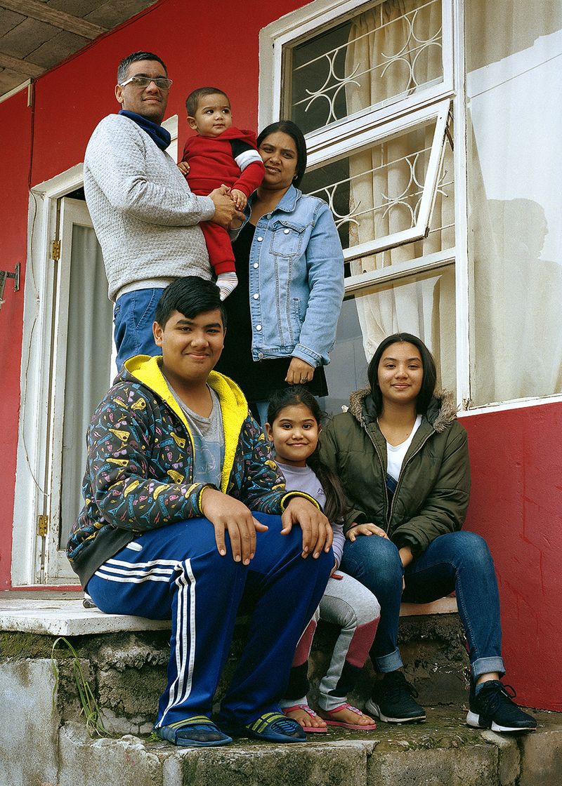 © Ayesha Kazim - Mahier and his family stand for a portrait outside of their home in Bo-Kaap.