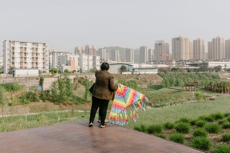 © Tianhu Yuan - The Kite Flyer. Near a newly constructed park, a resident prepares to fly a kite.