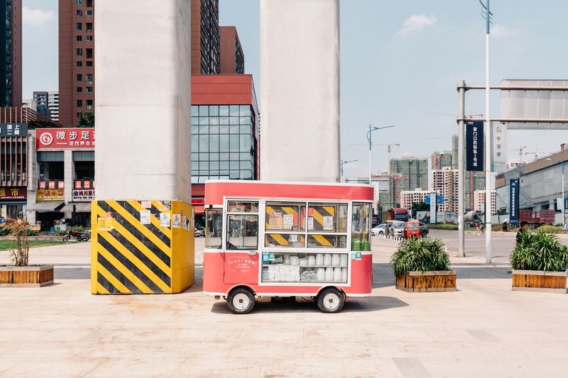 © Tianhu Yuan - This is a burgeoning community. A snack stall is under the huge railway pillars but it seems no customers.
