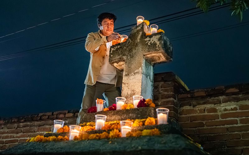 © Hong Yu Chan - A man stands before the cross, framed by darkness and flame.