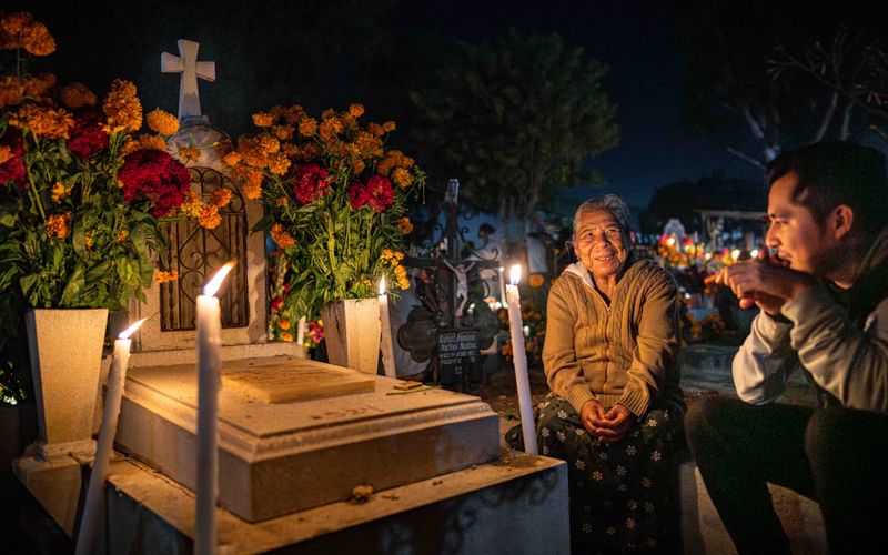 © Hong Yu Chan - Candles surround a grave as conversation continues softly into the night.