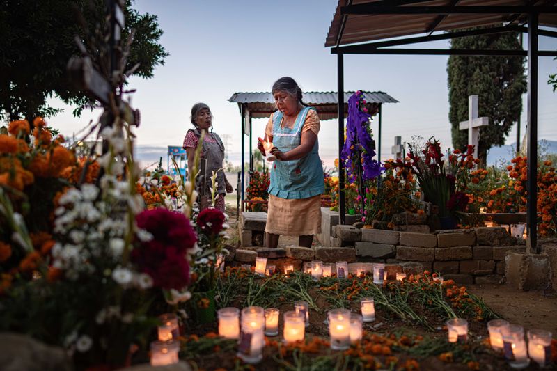 © Hong Yu Chan - Candles flicker across the cemetery, forming constellations of memory.