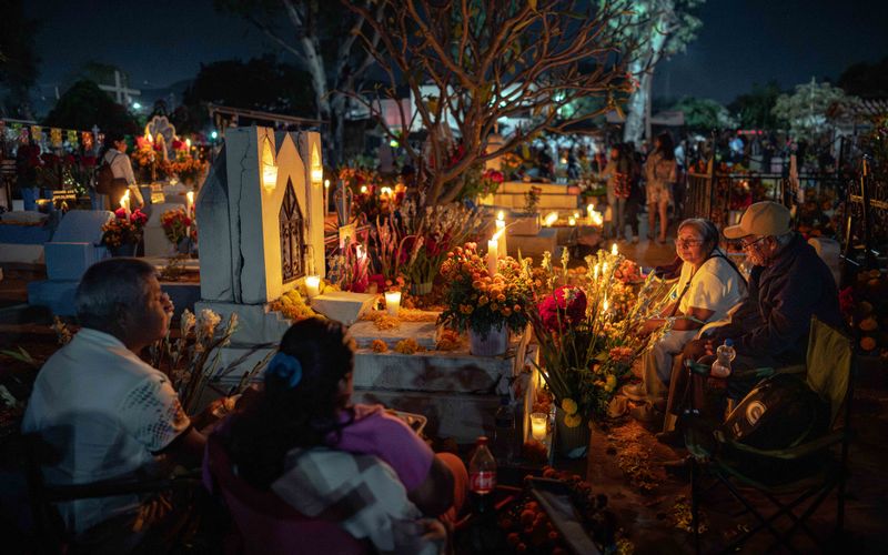 © Hong Yu Chan - Night falls as families sit beside the altar, holding space for memory and return.