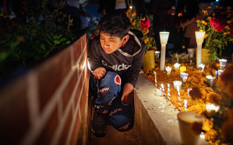 © Hong Yu Chan - A child leans close to the candles, learning remembrance through presence.
