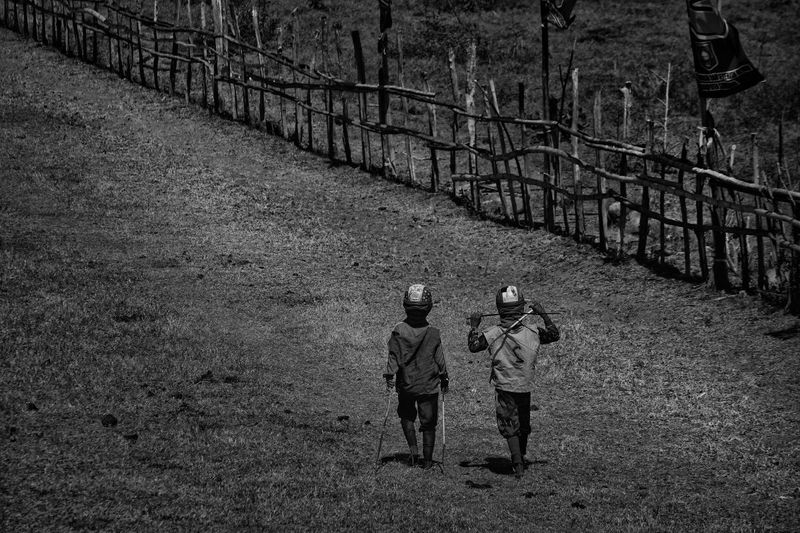 © Alain Schroeder - Indonesia, Sumbawa Island, Moyo, Two jockeys walking on the racetrack.