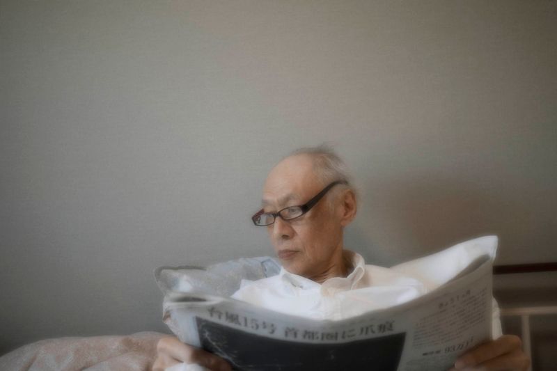 © Yusuke Takagi - My father reading newspaper at an assisted living facility