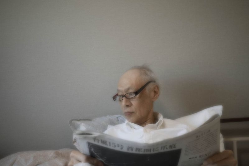 © Yusuke Takagi - My father reading newspaper at an assisted living facility