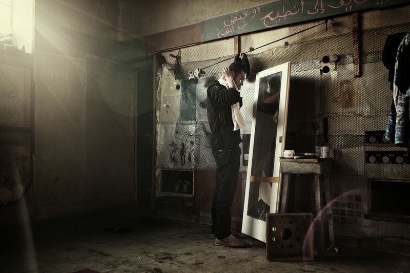 © Alessandro Penso - 2011. Athens . Greece. Mohammed from Algeria lives inside the old Colubia records factory.