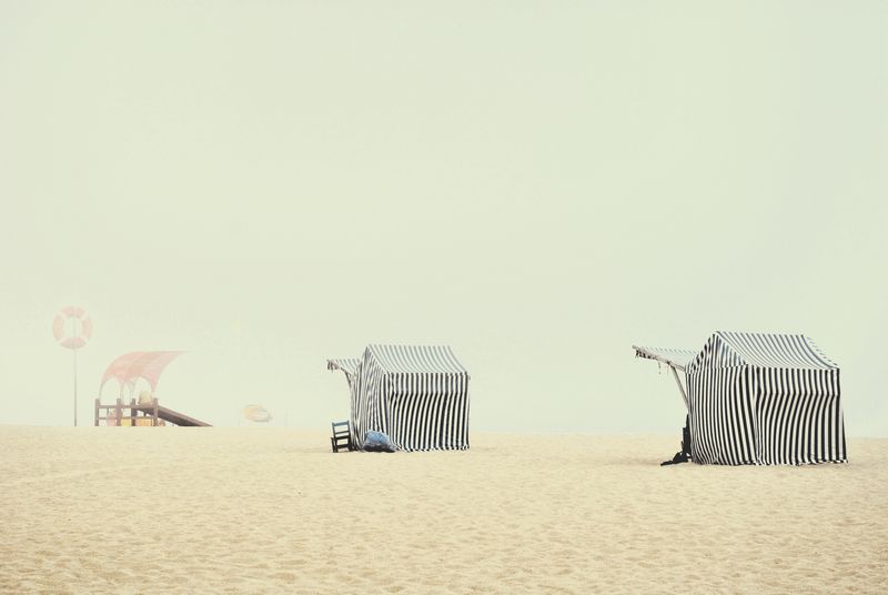 © Eduardo Rosas - Striped beach tents in morning haze, Portuguese Atlantic coast.