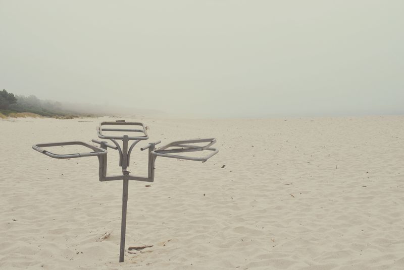 © Eduardo Rosas - Unused metal waste-bag frame on the beach.
