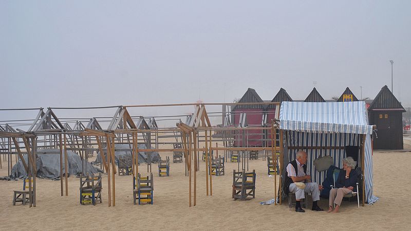 © Eduardo Rosas - A small human conversation unfolds inside a skeletal landscape of empty beach structures