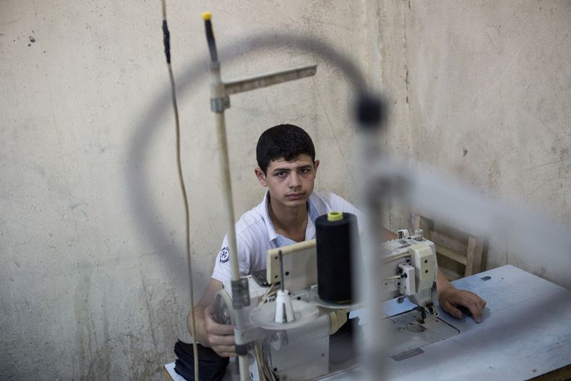 © valeriomuscella - A 15 years old Syrian boy is seen in his working place. May 2016. Gaziantep, Turkey.