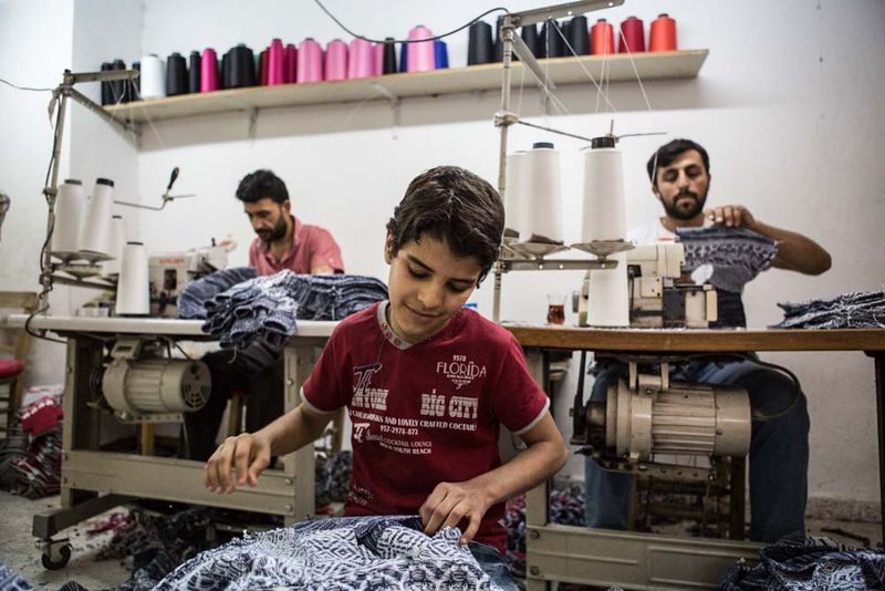 © valeriomuscella - A Syrian boy works in a Turkish textile workshop in Gaziantep, Turkey. May 2016.