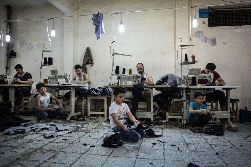 © valeriomuscella - Syrian children work more than 8 hours a day in a Turkish textile workshop. Gaziantep, Turkey. May 2016.