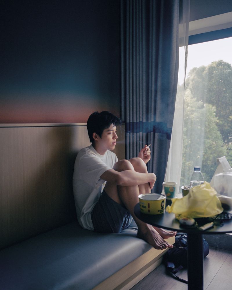 © Yongjie Hu - After our argument, he lit up a cigarette.
