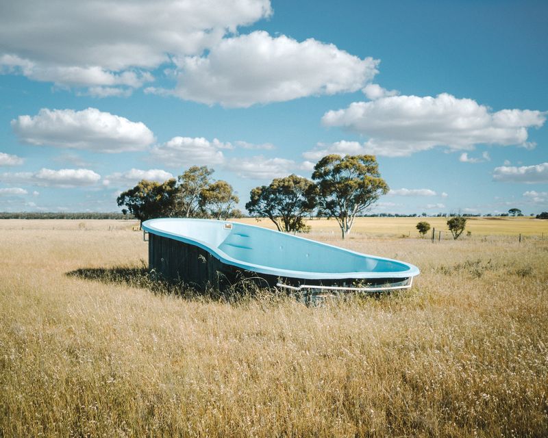 © Claudia Caporn - A discarded pool in the middle of a vacant paddock.