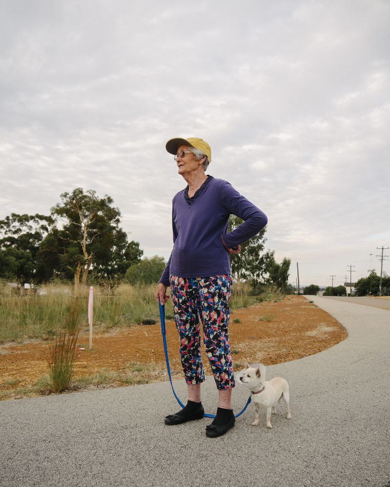 © Claudia Caporn - Beryl, 83, walking her dog through the town backstreets.
