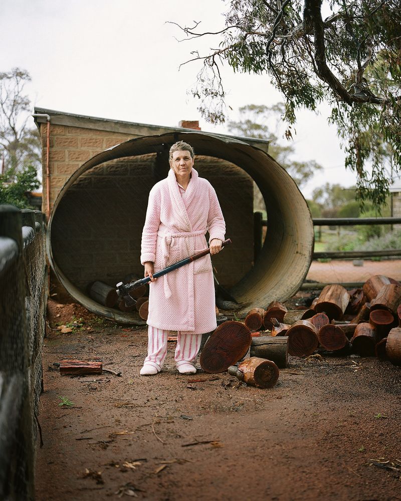© Claudia Caporn - My mother chopping wood in the rain, one winter's morning.