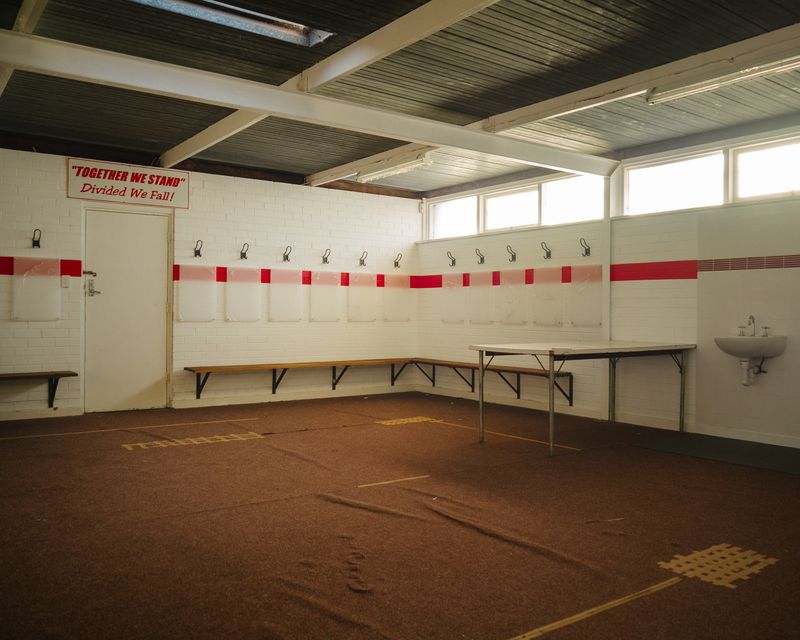 © Claudia Caporn - The empty football club change rooms.