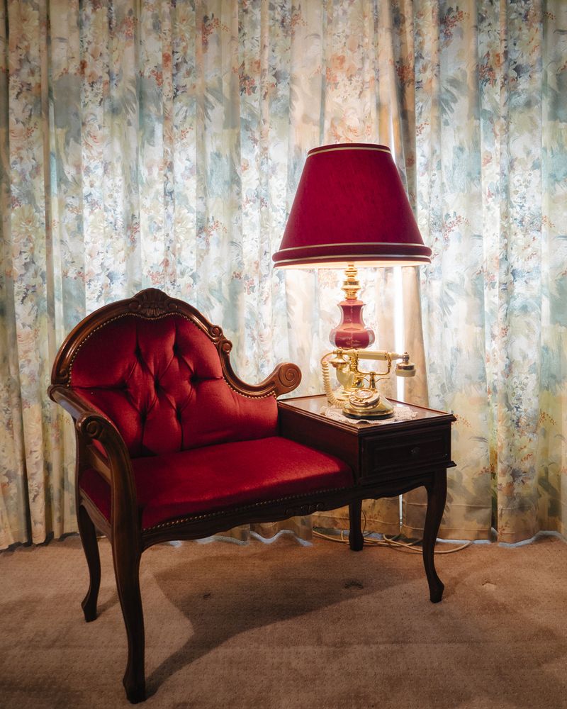 © Claudia Caporn - An old telephone that is still in use, and baroque chaise lounge belonging to Olive and Darryl, 71 year old residents.
