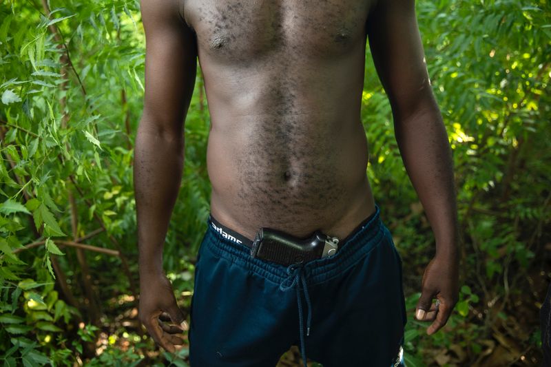 © RODRIGO ABD - A gang member in a field on the outskirts of Port-au-Prince, Wednesday, Oct. 6, 2021