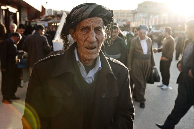 © Antonio Zambardino - halabja20 On Saturday men are walking in the city center of Halabja. Passerby at dusk.