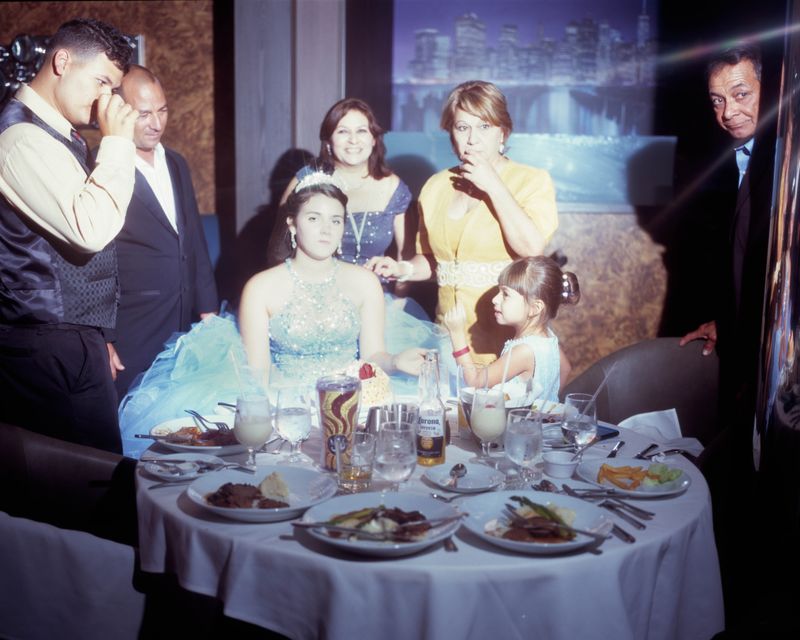 © Samantha Cabrera Friend - A quinceañera and her family unite with a multi course meal after the formal celebration.