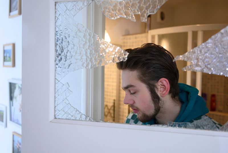 © Els Zweerink - Sammie at home through the window he hit in a panic attack (he sometimes suffers form panic attacks due to his ADHD).