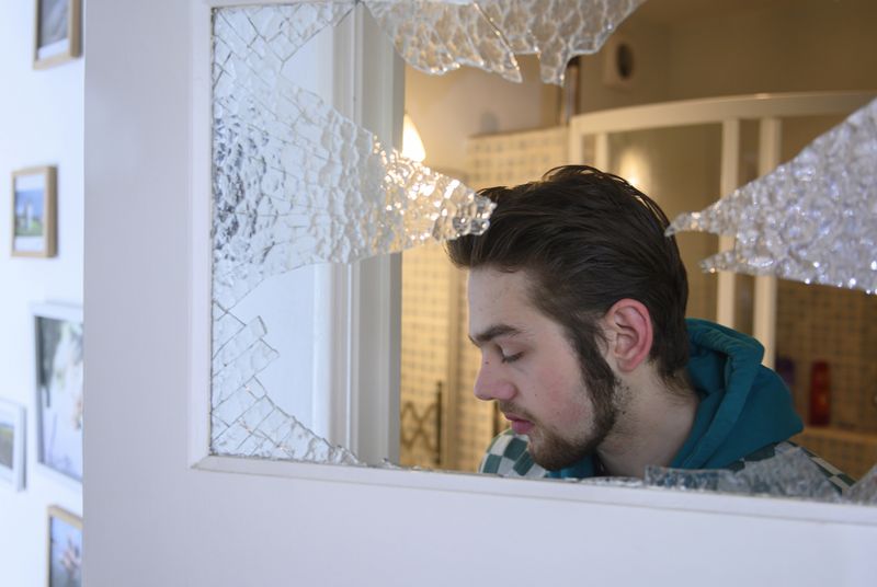 © Els Zweerink - Sammie at home through the window he hit in a panic attack (he sometimes suffers form panic attacks due to his ADHD).