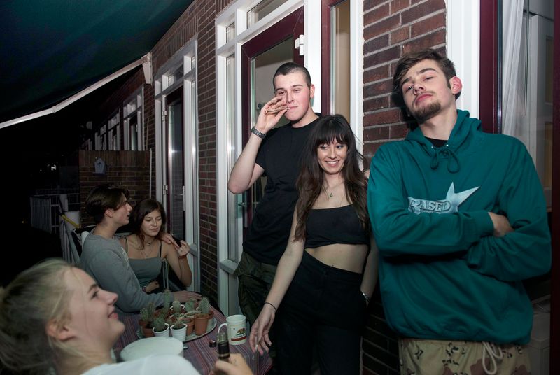 © Els Zweerink - Sammie on his 18th birthday. On the balcony they smoke the joint he just rolled (it's a double joint: an elloe).
