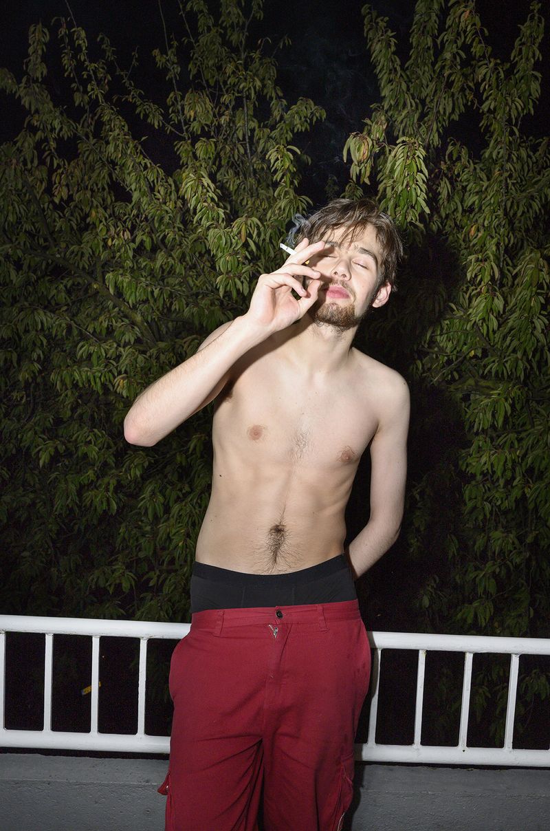 © Els Zweerink - Smoking at the balcony, and enjoying from a nice night out. He doesn't feel the cold.
