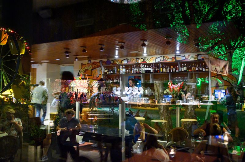 © Els Zweerink - At work, at the bar of the restaurant in the reflection of the window.