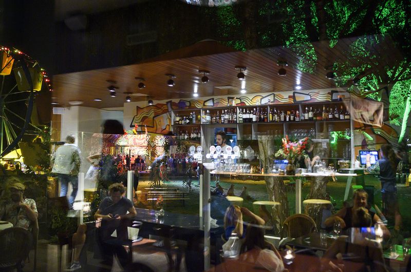 © Els Zweerink - At work, at the bar of the restaurant in the reflection of the window.