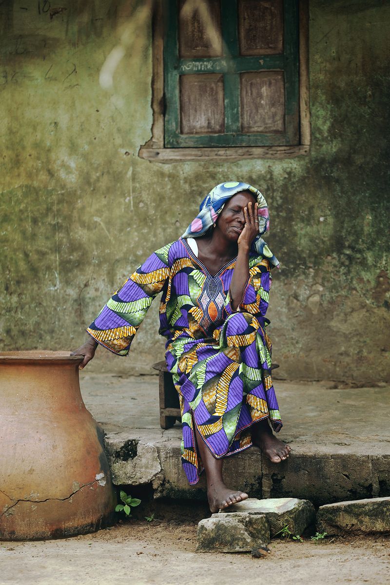 © Natalia Kovachevski - "The Widow" - A widow seated in front of her late husband's house, to which she can no longer access.