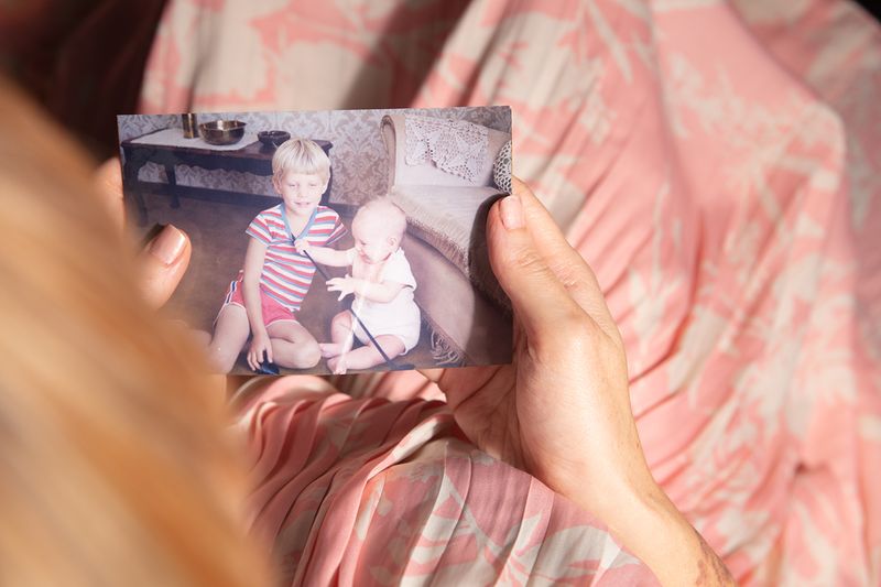© Stefanie Langenhoven - Self portrait, looking at a photograph of my brother and I from 1981, 2023