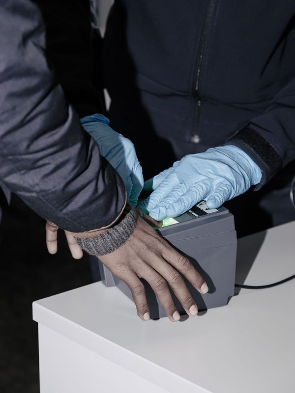 © Salvatore Vitale - Fingerprint registration during an immigration control at the Italian border for an Eritrean asylum seeker.