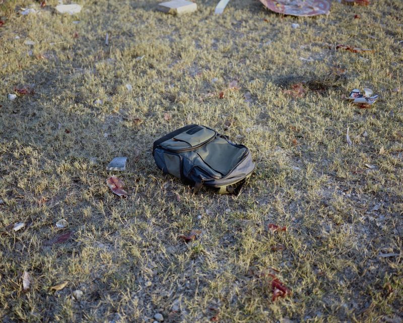 © Jialong Yang - Untitled (backpack on grass)