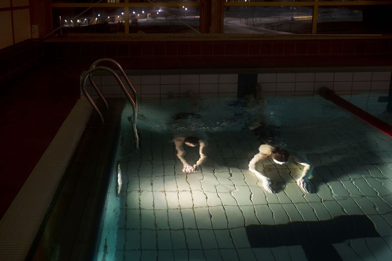 © Axelle de Russé - Two young students from the Longyearbyen University of Science enjoy this swimming pool after school. February 2019, 7 pm.